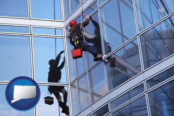 a window washer, washing office building windows - with Connecticut icon