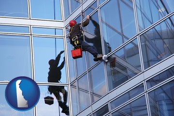 a window washer, washing office building windows - with Delaware icon