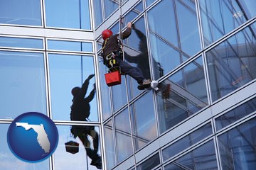 a window washer, washing office building windows - with Florida icon