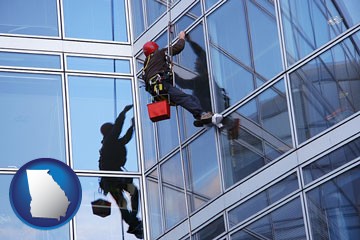 a window washer, washing office building windows - with Georgia icon
