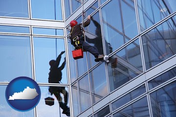 a window washer, washing office building windows - with Kentucky icon