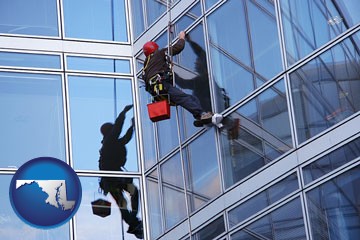 a window washer, washing office building windows - with Maryland icon