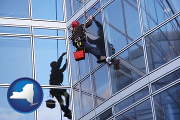 a window washer, washing office building windows - with New York icon