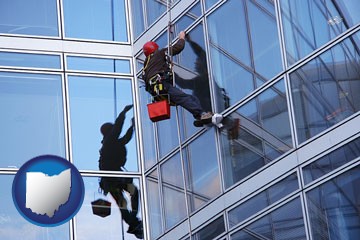 a window washer, washing office building windows - with Ohio icon