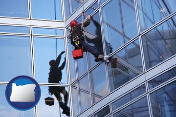 a window washer, washing office building windows - with Oregon icon
