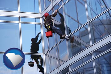 a window washer, washing office building windows - with South Carolina icon