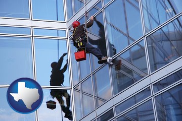 a window washer, washing office building windows - with Texas icon