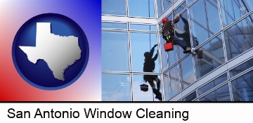 a window washer, washing office building windows in San Antonio, TX